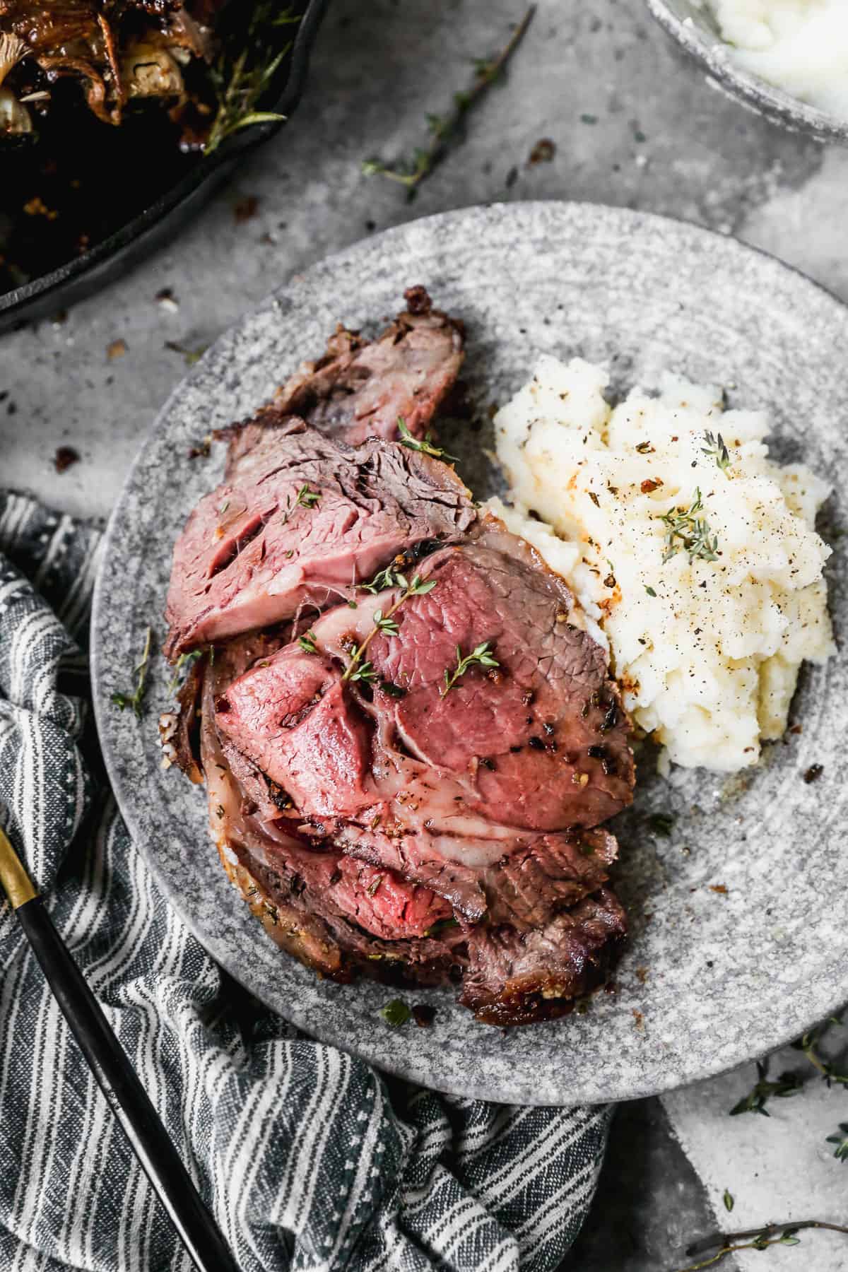 A perfectly sliced piece of prime rib accompanied by creamy mashed potatoes, illustrating the ideal serving suggestion.